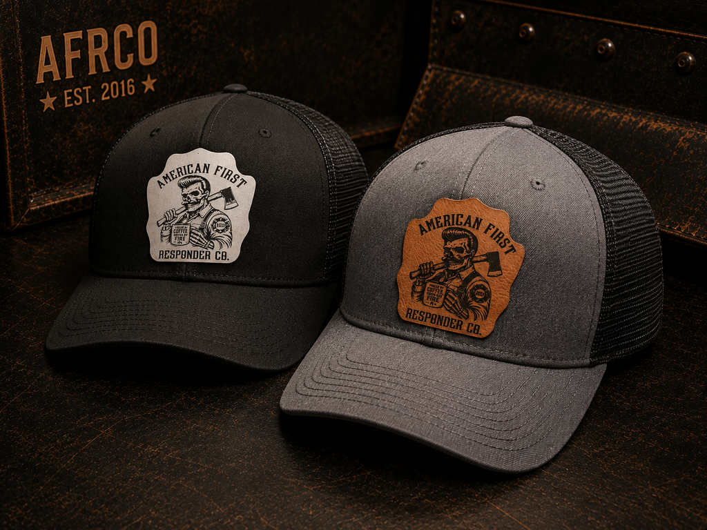 Two trucker-style caps displayed on a dark rustic surface. The left cap is black with a white patch reading 'American First Responding Co.