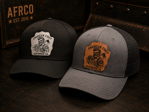 Two trucker-style caps displayed on a dark rustic surface. The left cap is black with a white patch reading 'American First Responding Co.
