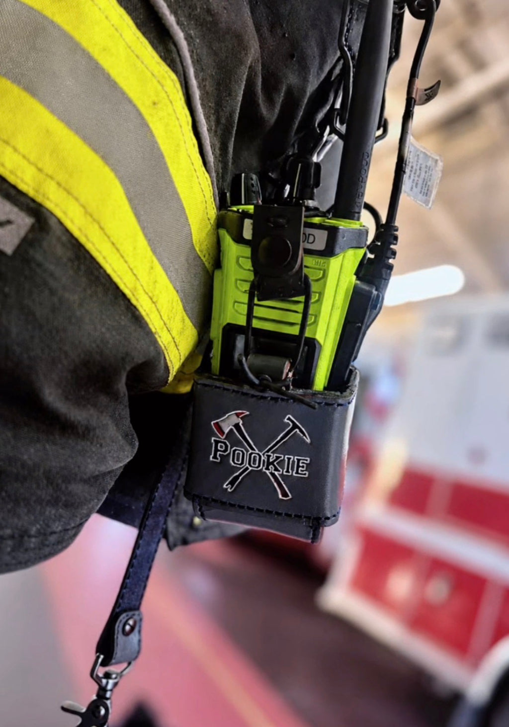 Custom leather firefighter radio strap attached to firefighter turnout gear