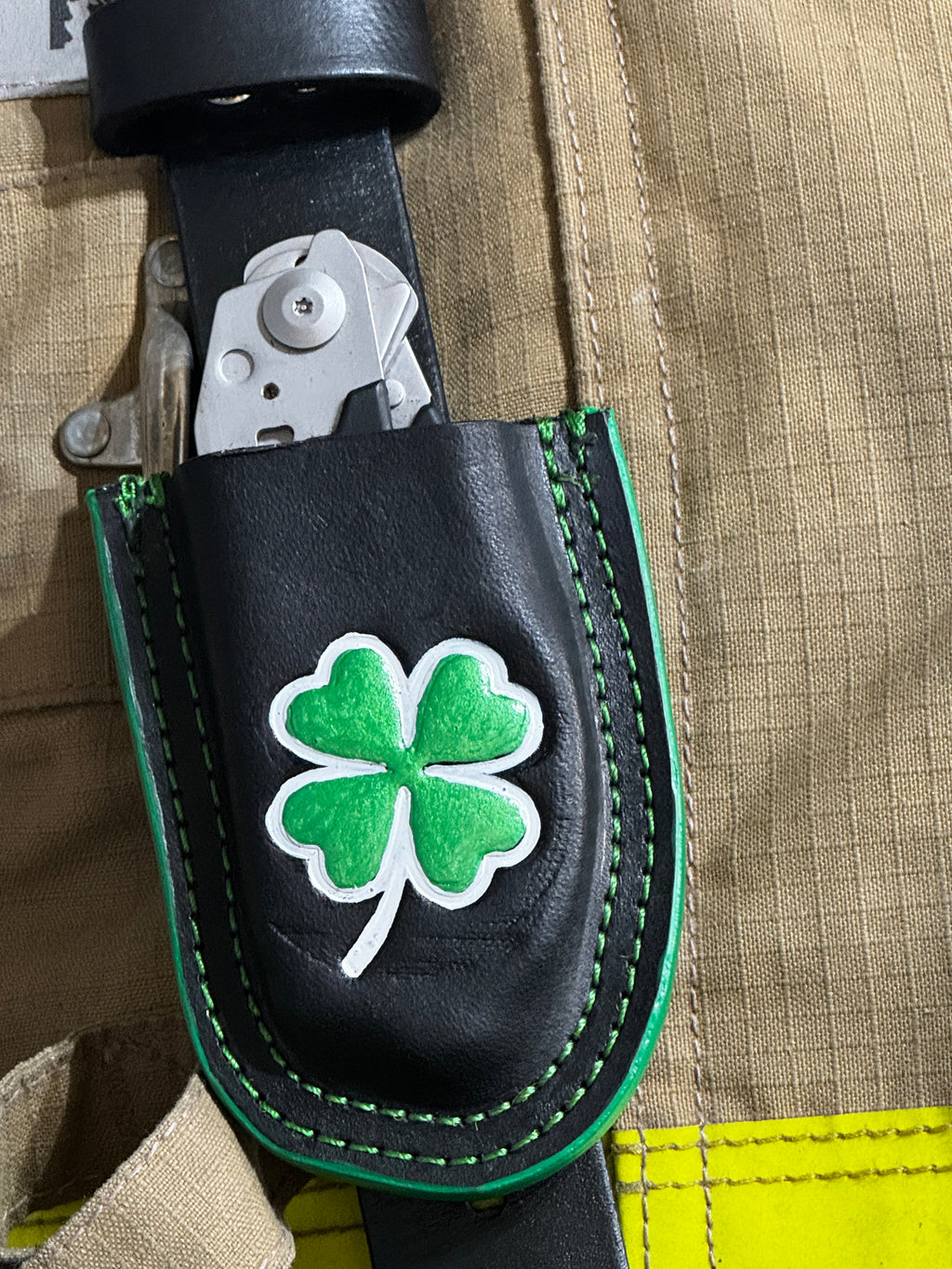 Black leather Raptor Shears holster with green shamrock design