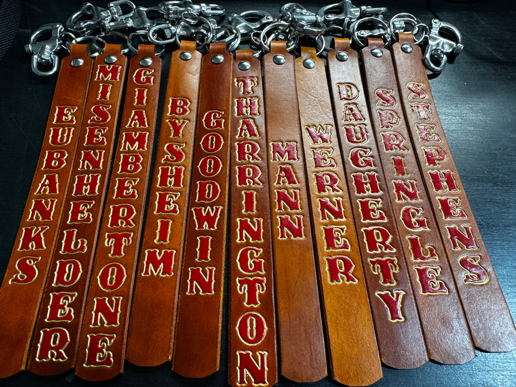 Personalized firefighter SCBA quick release pulls made from full-grain English bridle leather with heavy-duty metal hardware.