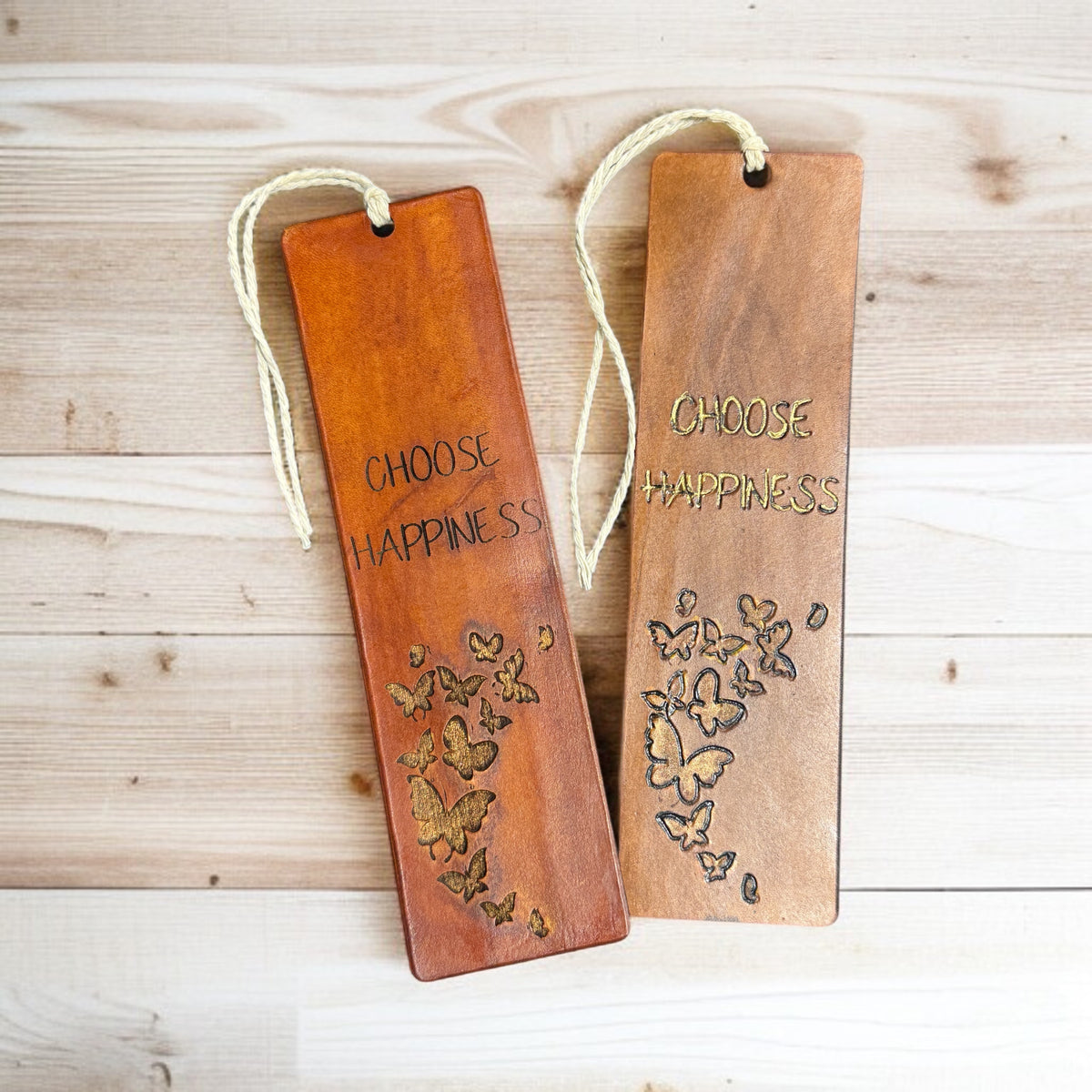 Inspirational leather bookmarks engraved with butterflies and the words "Choose Happiness"