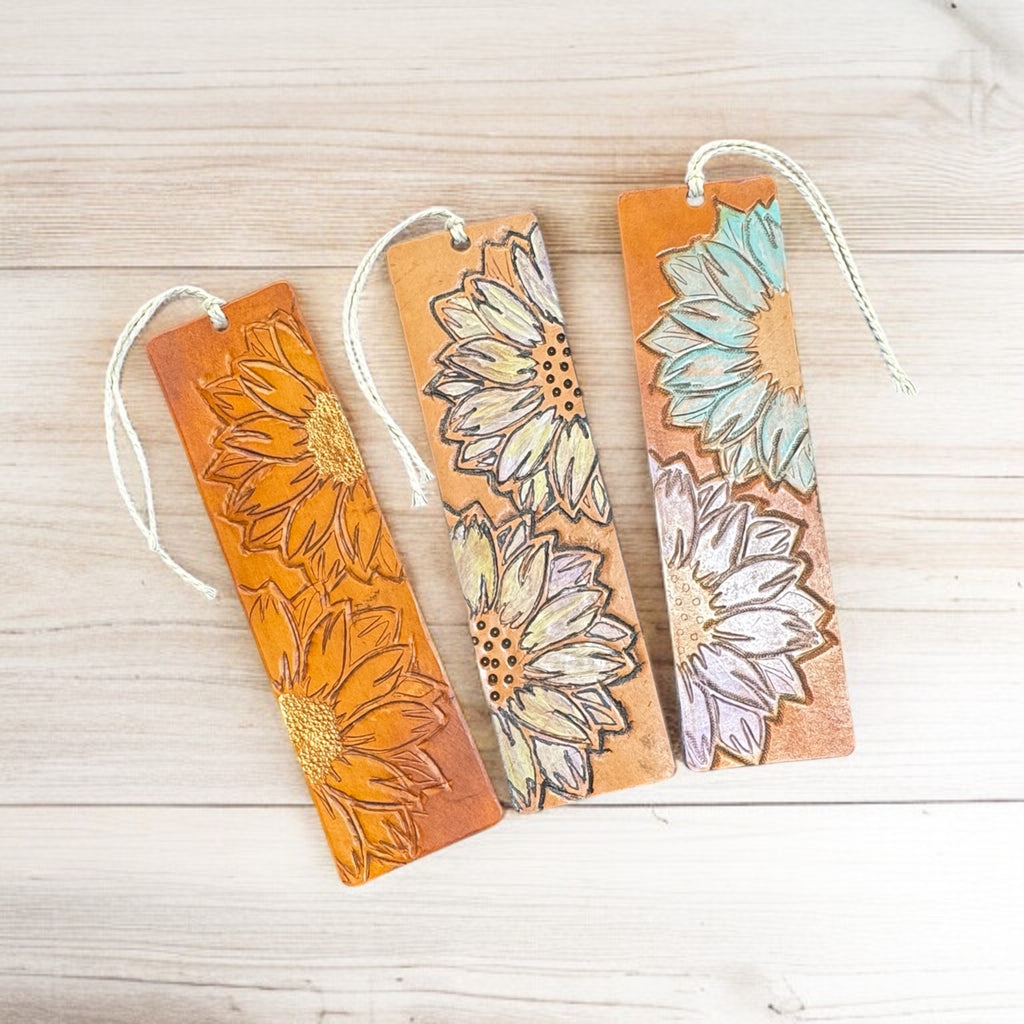 Artisan leather bookmarks with colorful sunflower designs, handcrafted by a small first responder-owned business.

