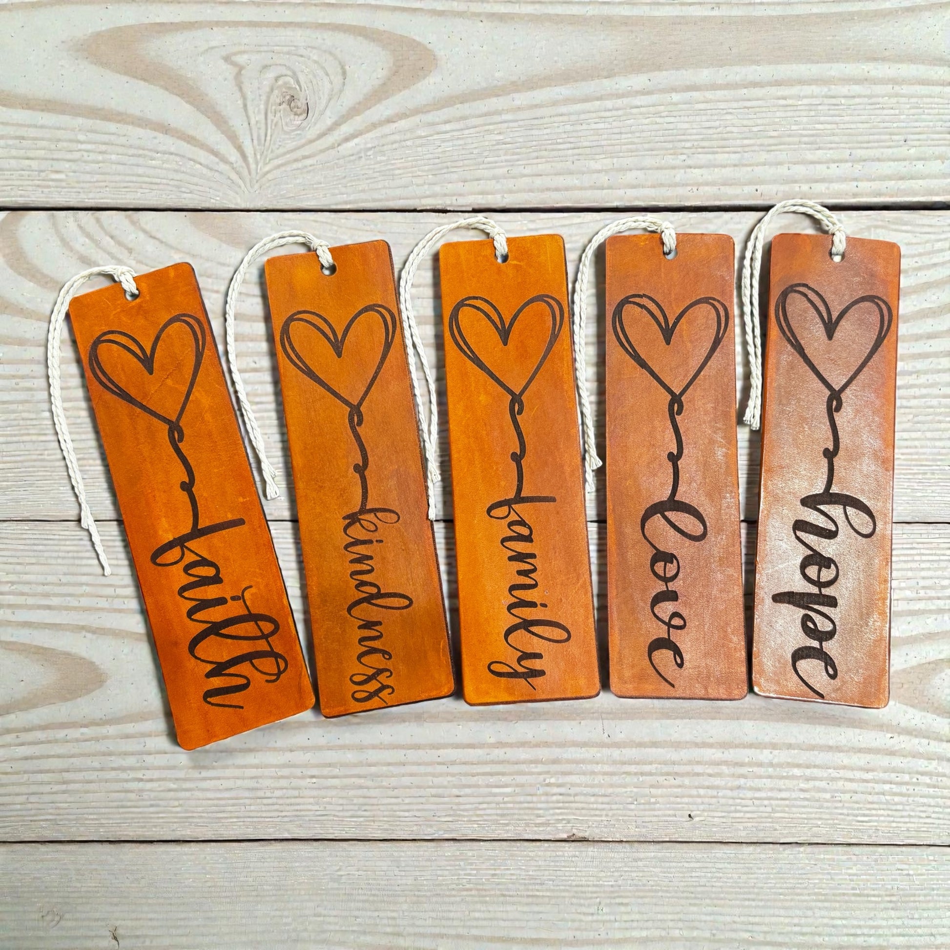 Handmade leather bookmarks engraved with Faith, Family, Love, Kindness, and Hope