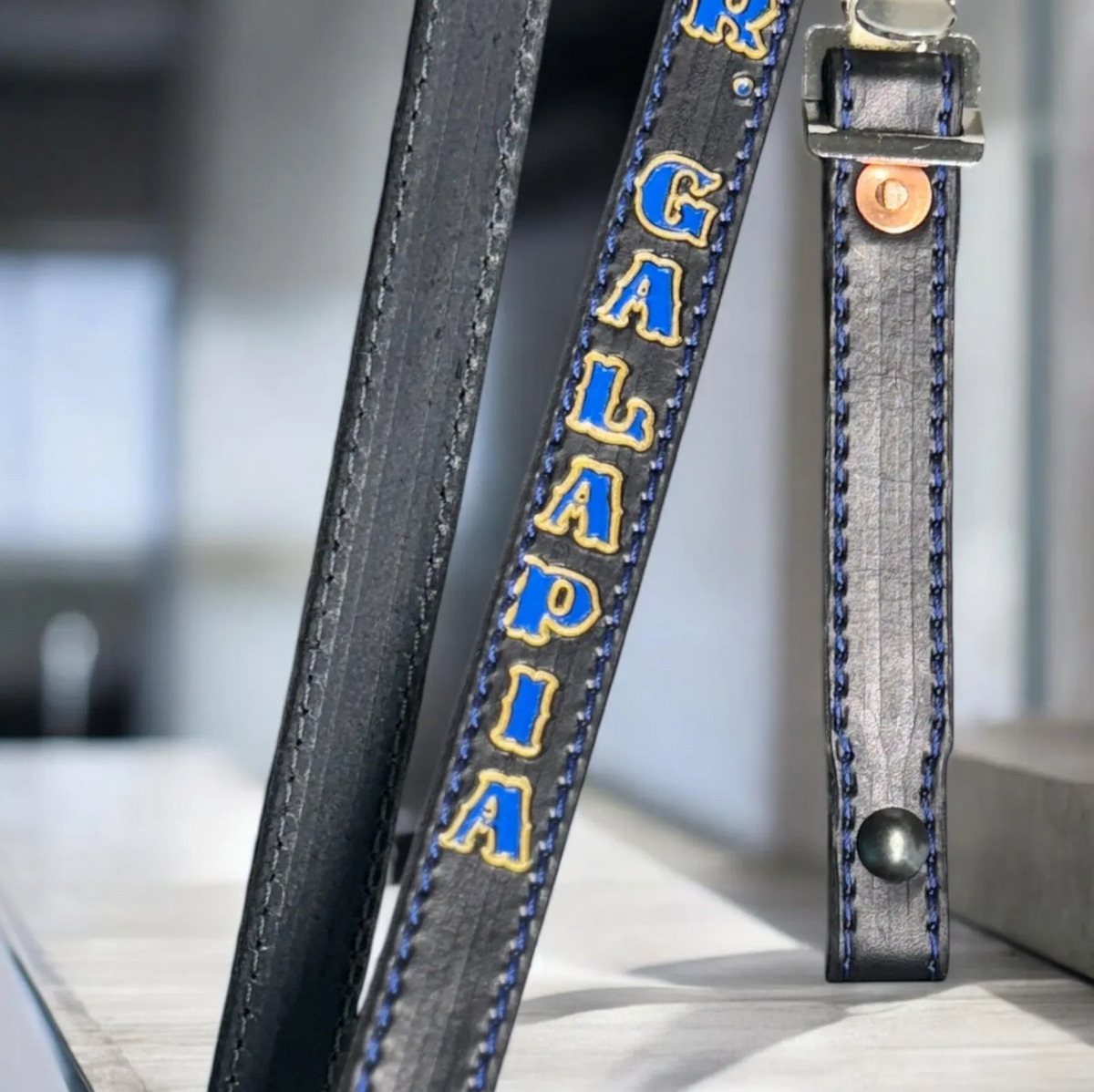 Custom leather firefighter helmet chin strap with personalized name and premium hardware.