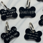 Small bone-shaped dog tag engraved with sarcastic phrase