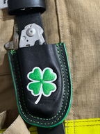 Black leather sheath with a green four-leaf clover 