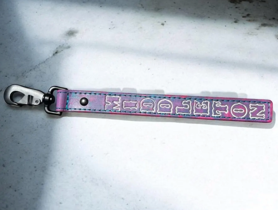 Full-length personalized firefighter glove strap featuring a cotton candy pink and blue leather finish with heavy-duty hardware.