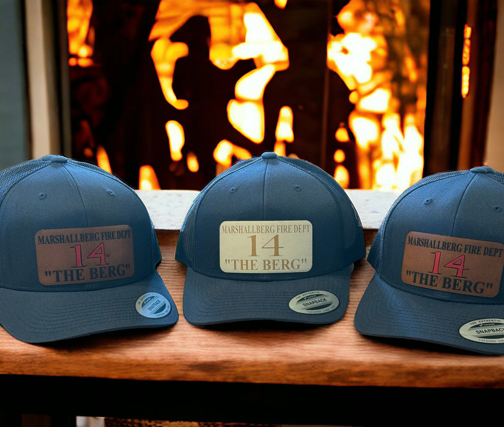 Custom Yupoong snapback trucker hat with mesh back and engraved rawhide leatherette patch, featuring personalized fire station text.