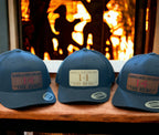 Custom Yupoong snapback trucker hat with mesh back and engraved rawhide leatherette patch, featuring personalized fire station text.