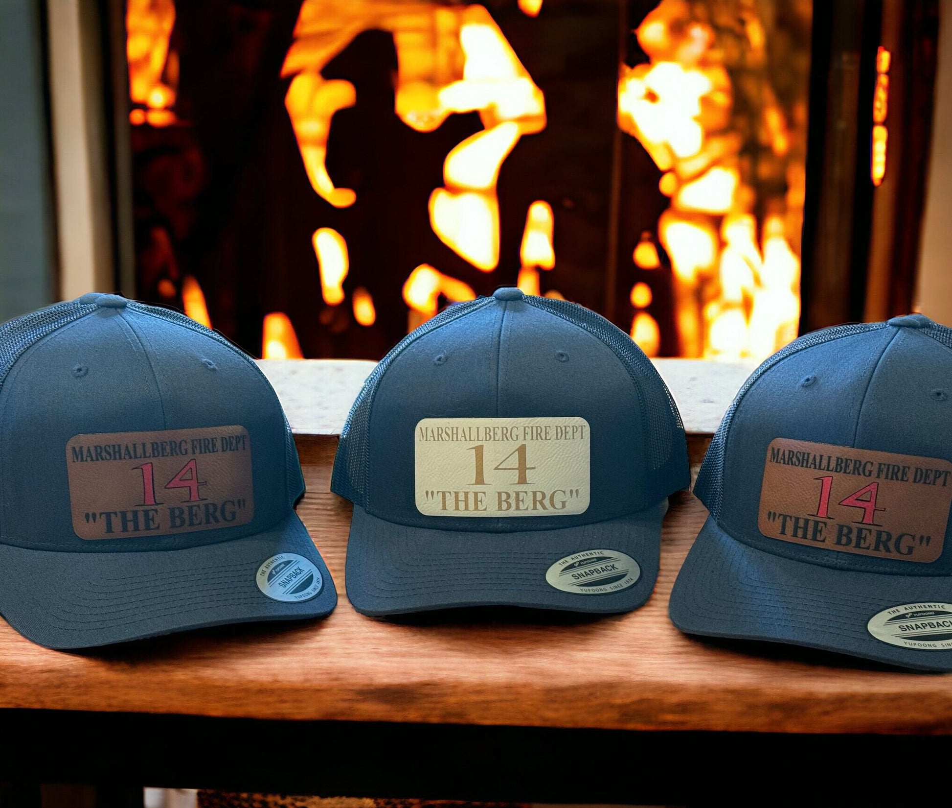 Custom Yupoong snapback trucker hat with mesh back and engraved rawhide leatherette patch, featuring personalized fire station text.