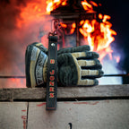 Personalized leather firefighter glove strap attached to structural firefighting gloves with custom painted name.