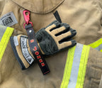 Close-up of personalized leather firefighter glove strap showing custom paint, stitching, and premium leather.