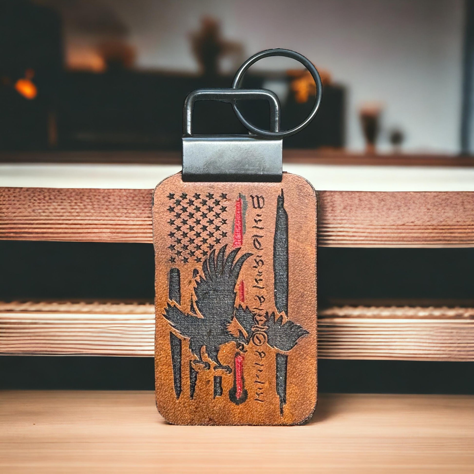 Handcrafted full-grain leather keychain with Thin Red Line American flag, a soaring eagle, and the words "We the People," symbolizing firefighter tribute and patriotism.