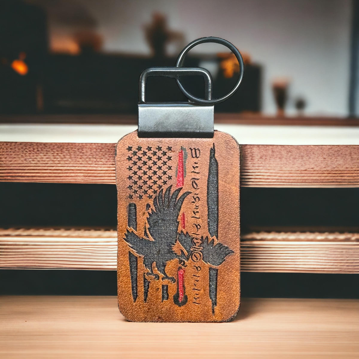 Handcrafted full-grain leather keychain with Thin Red Line American flag, a soaring eagle, and the words "We the People," symbolizing firefighter tribute and patriotism.