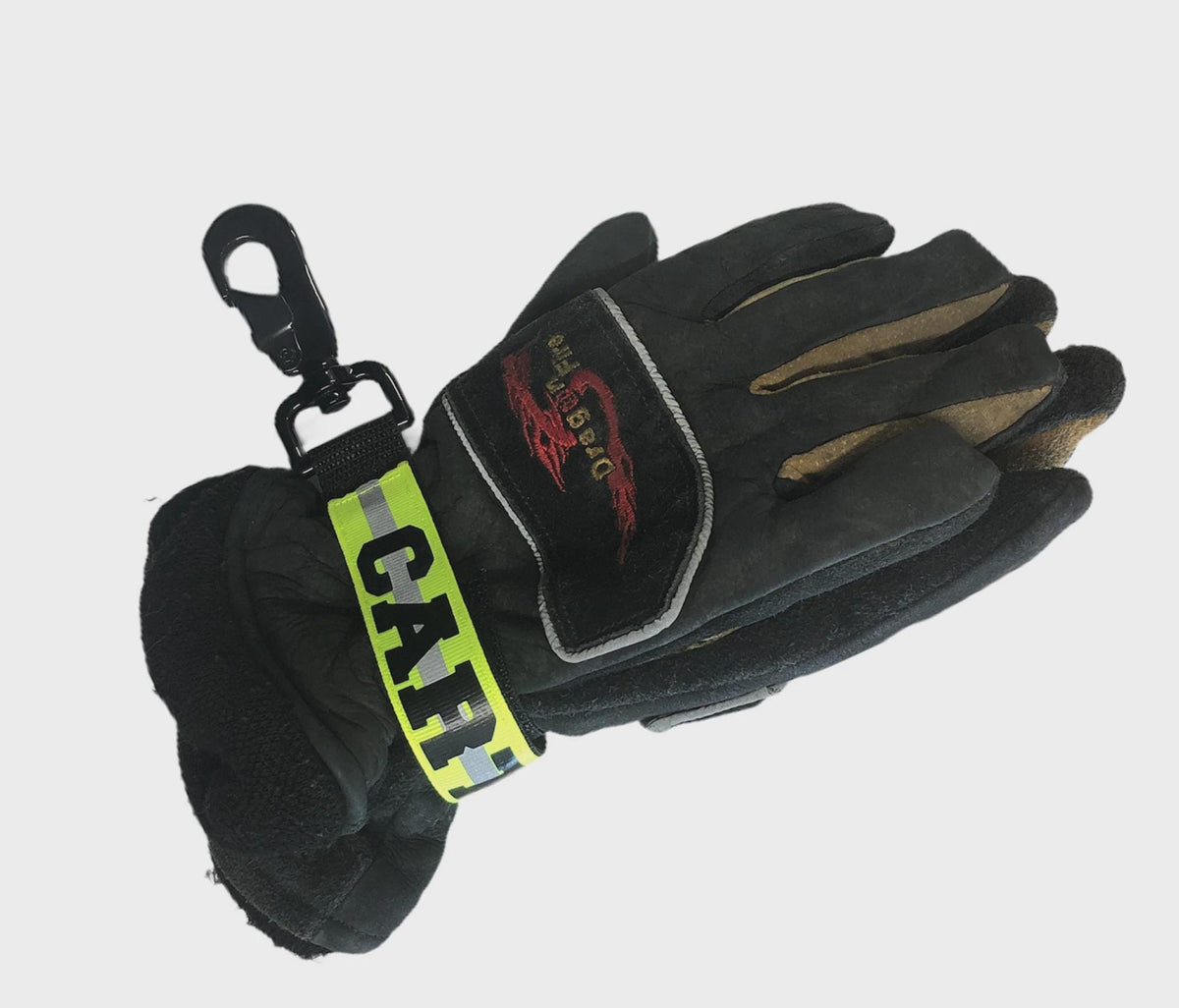Personalized firefighter webbing glove strap with yellow reflective name, heavy-duty hardware, and structural firefighting gloves.