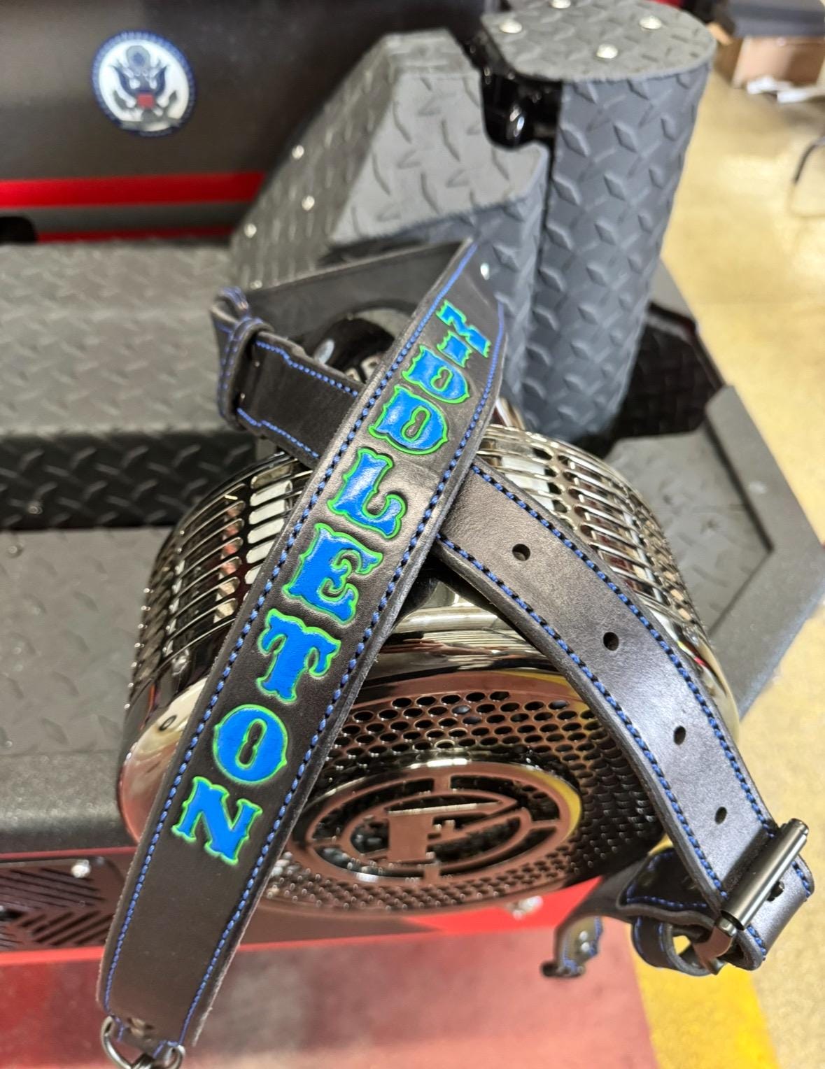 Close-up of personalized leather firefighter radio strap with custom name