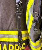 Black leather firefighter radio strap showing heavy-duty hardware