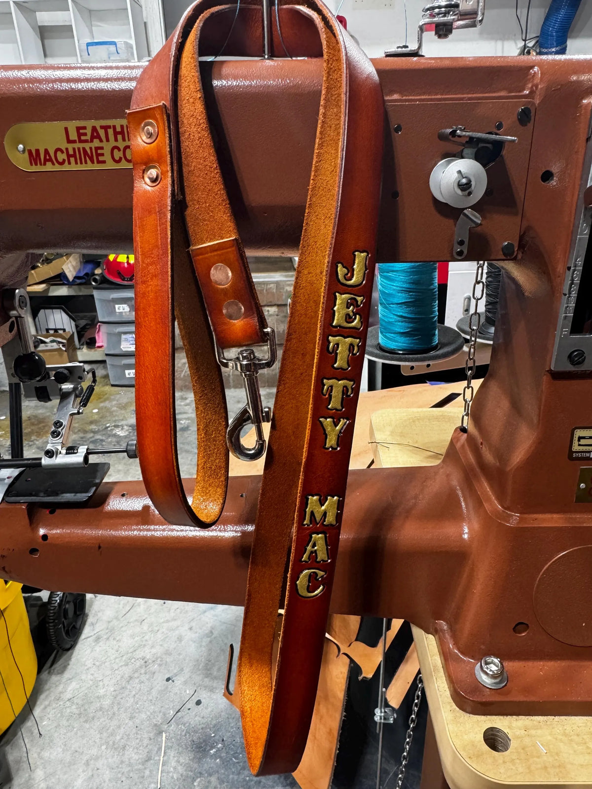 Personalized leather dog leash handcrafted from full-grain English bridle leather with custom stamped name and heavy-duty hardware.